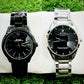 Two Rolex watches, one black and one silver, on a white surface with grass in the background.